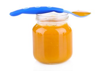 Baby food with carrot isolated on white