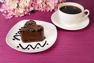 Sweet cake with chocolate on plate on table close-up