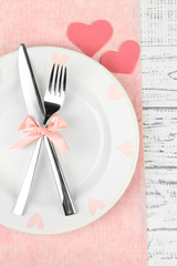 Romantic holiday table setting, on wooden background