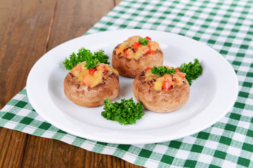 Stuffed mushrooms on plate on table close-up