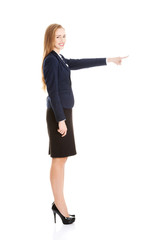 Beautiful business woman pointing on copy space.
