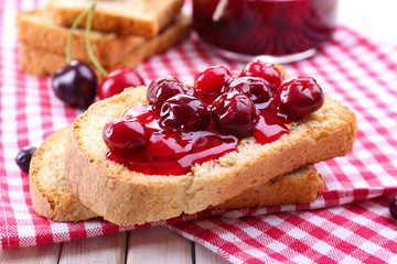 Delicious toast with jam on table close-up