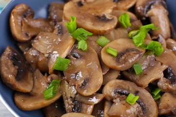 Delicious fried mushrooms in pan close-up