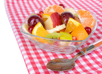 Sweet fresh fruits in bowl on table close-up