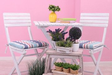 Garden chairs and table with flowers