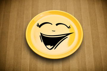 Happy smiley cartoon face on colorful dish plate