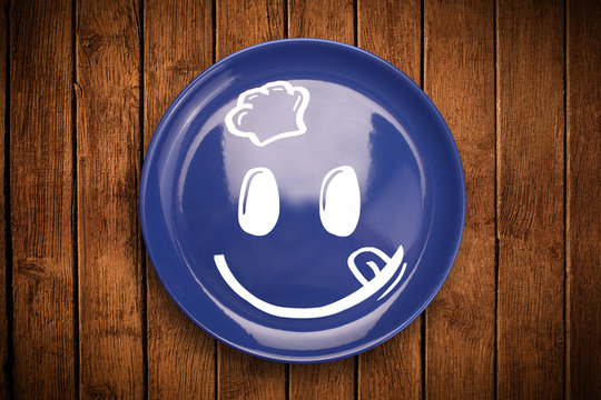 Happy smiley cartoon face on colorful dish plate