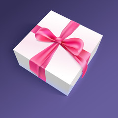 White gift box with red ribbon and bow