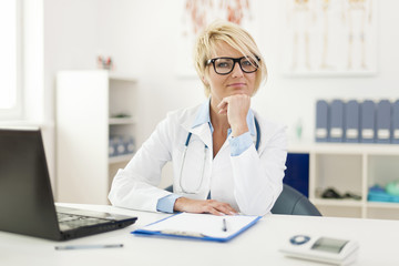 Portrait of beautiful young female doctor in office