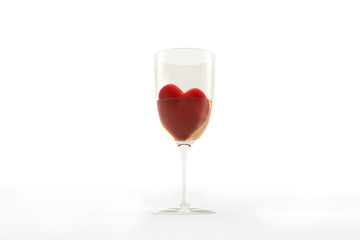 Red heart dug in wine glass