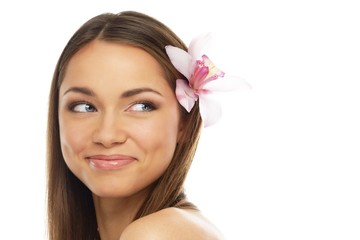 Young beautiful brunette woman with orchid flower