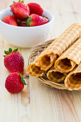 Homemade waffle with strawberry on a wooden surface