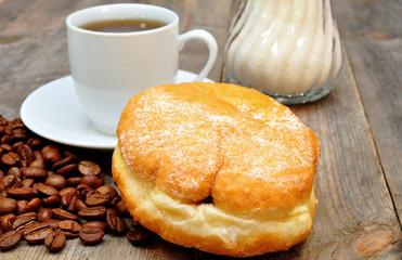coffee and donut on wooden table