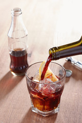 Pouring wine into kalimotxo mixture glass