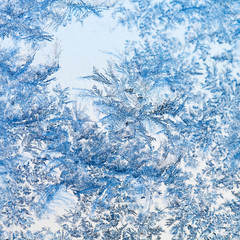 Fototapeta premium snowflakes and frost pattern on glass close up