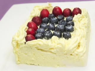 piece of cheesecake soufflé with  blueberries, cranberries