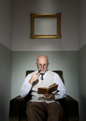 Professor reading in armchair