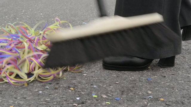 after party - woman sweeping the ground with broom
