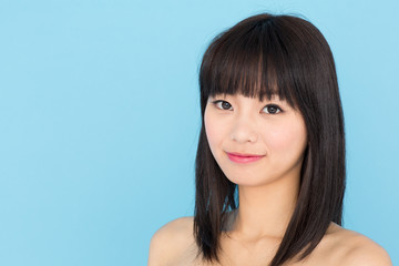 attractive asian woman on blue background