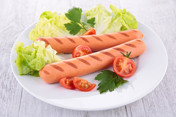 plate of sausage and salad