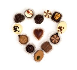 Chocolate pralines in heart shape on a white background