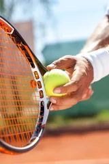 Tuinposter hand with tennis ball and racket © luckybusiness