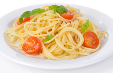 Delicious spaghetti with tomatoes on plate close-up