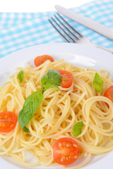 Delicious spaghetti with tomatoes on plate on table close-up