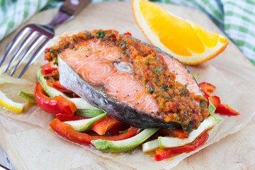 Steak red fish salmon on vegetables, zucchini and paprika