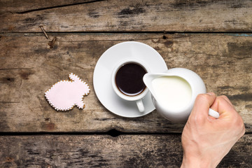 Coffee with gingerbread rabbit on wood background. 