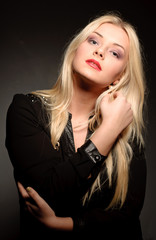 Fototapeta premium Beautiful woman with long straight blond hair. Fashion model pos