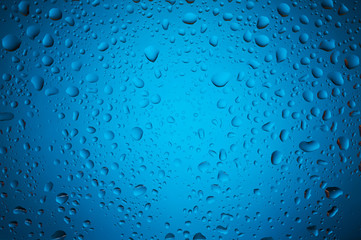 Blue water drops on glass