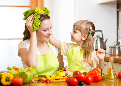 mother and kid cooking and having fun in kitchen