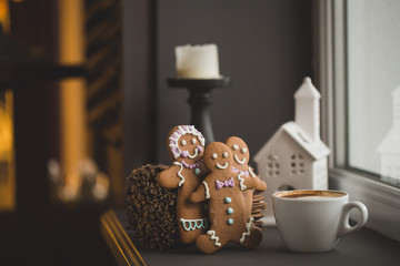 Gingerbread cookie men in a hot cup of cappuccino