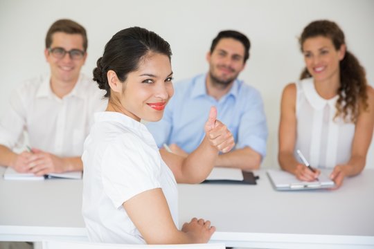 Female candidate gesturing thumbs up - Powered by Adobe