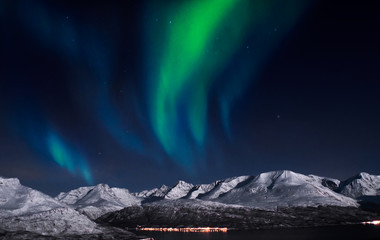 Northern lights above fjords in northern Norway.