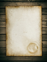 Vintage paper sheet at wood