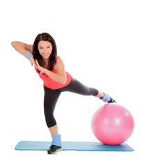 Fototapeta na wymiar Attractive young female with fitness ball in sport center