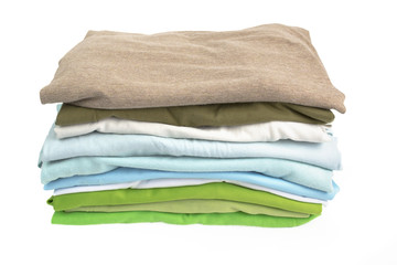 A stack of folded shirts on white background