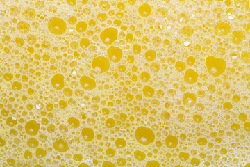 beautiful background of yellow suds bubbles closeup.