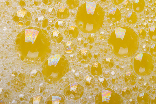 beautiful yellow background with bubbles of foam closeup