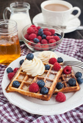 Belgian waffles with whipped cream and fresh berries