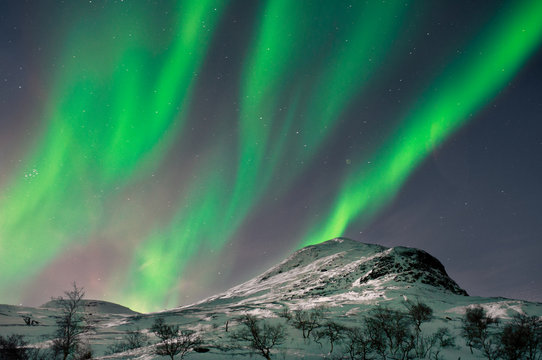 Northern lights above mountain top