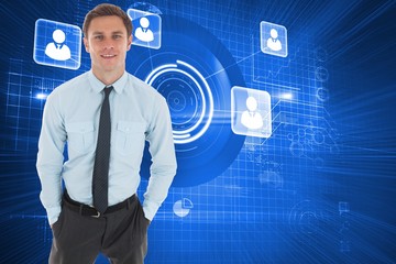 Composite image of happy businessman standing with hands in pock