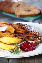 Duck leg with apple and cowberry sauce.