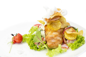 salad with chicken and potatoes on a white plate in a restaurant