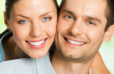 Young happy smiling attractive couple, outdoors