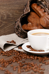 Cup of coffee surronded by rye bread and coffee beans