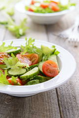 Vegatable salad from fresh cucumbers, lettuce and cherry tomatoe