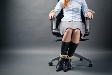 Tied Up Businesswoman in a Chair
